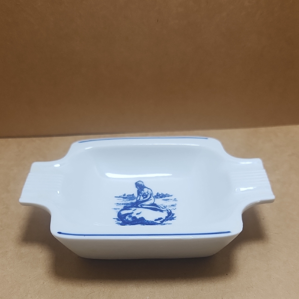 White Dish with Blue Design With Woman On Rock